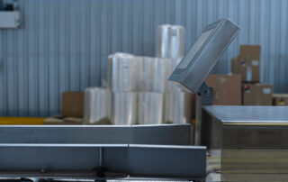 sideview of industrial scale with boxes stacked in the background