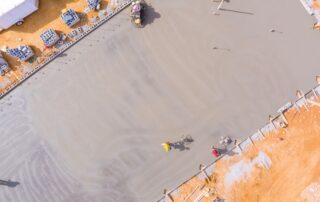 After concrete has been poured, mason works to polish concrete using concrete polishing machines.